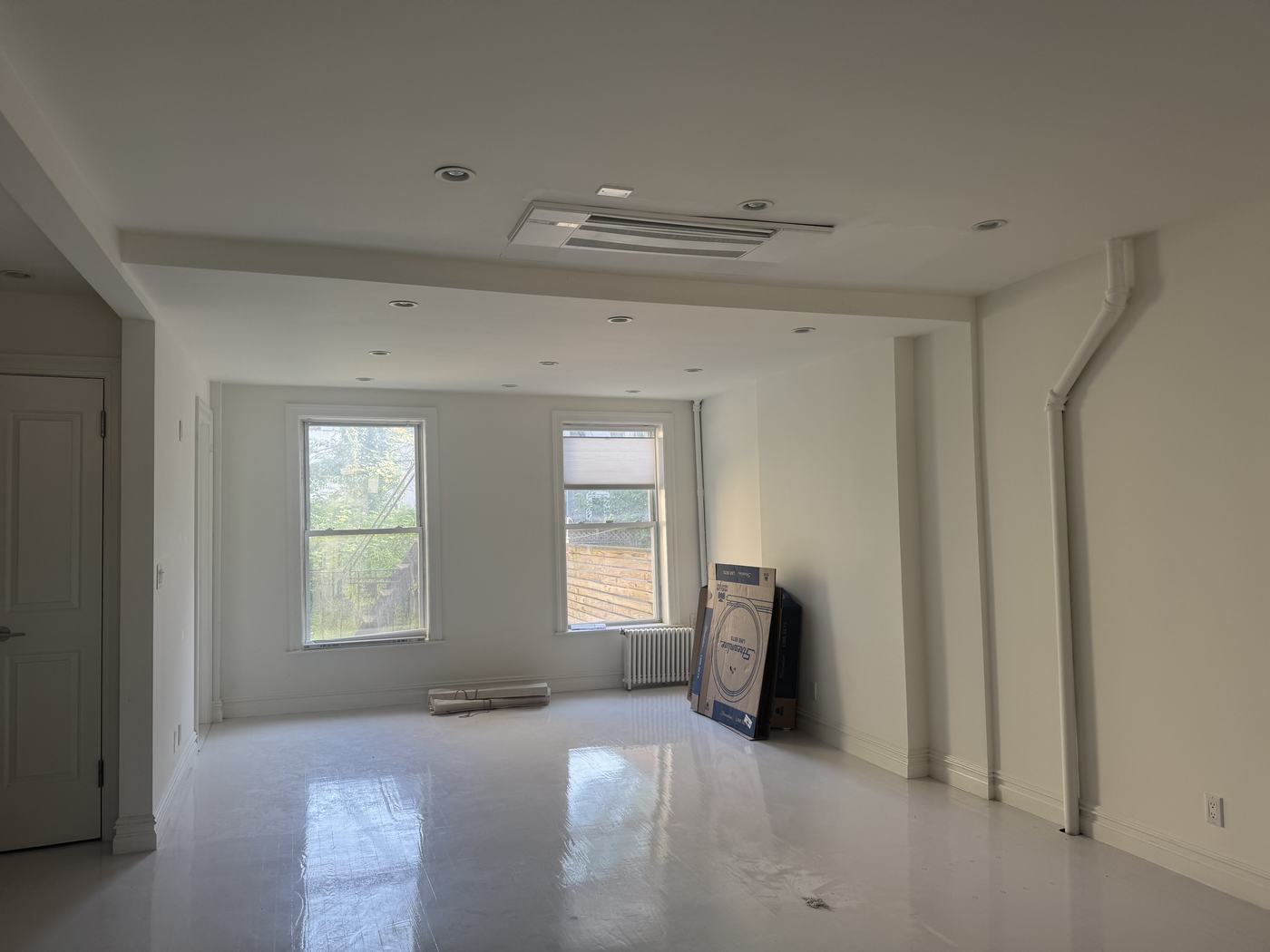 Concealed ducted mini-split ceiling unit in a clean Brooklyn interior